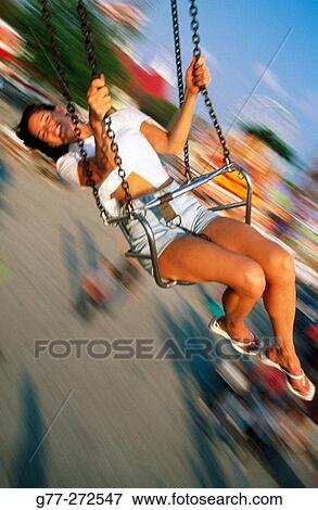 Woman on wave swinger carousel in amusement park. Florida. USA View Large Photo Image Stock Photo - Woman on wave swinger carousel in amusement park. Florida. USA. Fotosearch
