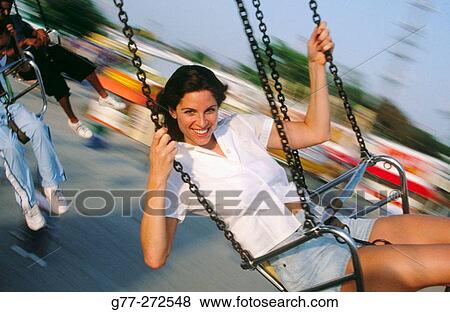 Woman on wave swinger carousel in amusement park. Florida. USA View Large Photo Image Stock Photo - Woman on wave swinger carousel in amusement park. Florida. USA. Fotosearch