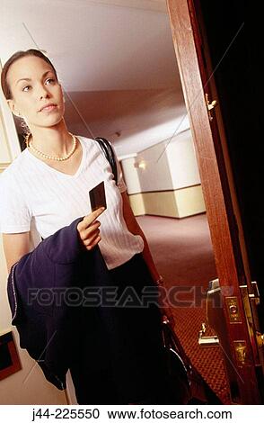 Woman opening door of hotel room View Large Photo Image Stock Image - Woman opening door of hotel room. Fotosearch