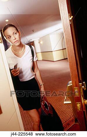 Woman opening door of hotel room View Large Photo Image Stock Photo - Woman opening door of hotel room. Fotosearch