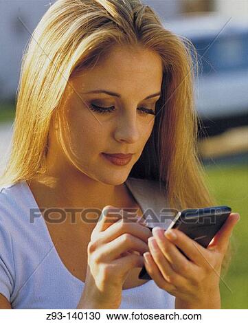 Woman outdoors using palm pilot View Large Photo Image Stock Image - Woman outdoors using palm pilot. Fotosearch