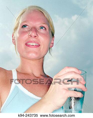 Woman outside drinking water View Large Photo Image Stock Photography - Woman outside drinking water. Fotosearch