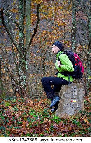 Stock Photography - Woman over a road signal Sobrescobio Alba river route Redes Natural Park, Asturias, Spain. Fotosearch
