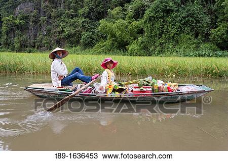 Woman paddling on the river to the market in Ninh Binh Area of northern Vietnam View Large Photo Image Stock Image - Woman paddling on the river to the market in Ninh Binh Area of northern Vietnam. Fotosearch