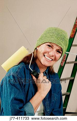 Woman painting home View Large Photo Image Stock Image - Woman painting home. Fotosearch