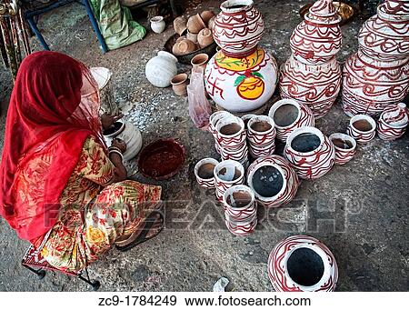 Woman painting pots at a pottery stall Jodhpur, Rajasthan, India View Large Photo Image Stock Photo - Woman painting pots at a pottery stall Jodhpur, Rajasthan, India. Fotosearch