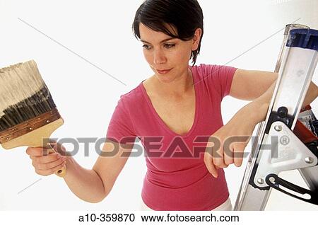 Stock Image - Woman painting walls. Fotosearch