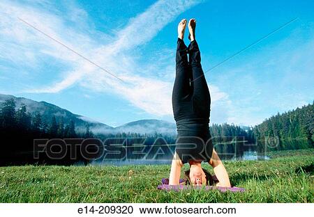 Woman performing yoga along Wark Lake. Ketchikan, Alaska. USA View Large Photo Image Stock Image - Woman performing yoga along Wark Lake. Ketchikan, Alaska. USA. Fotosearch