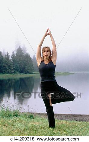 Woman performing yoga along Wark Lake. Ketchikan, Alaska. USA View Large Photo Image Stock Photo - Woman performing yoga along Wark Lake. Ketchikan, Alaska. USA. Fotosearch