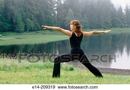 Woman performing yoga along Wark Lake. Ketchikan, Alaska. USA View Large Photo Image Stock Photo - Woman performing yoga along Wark Lake. Ketchikan, Alaska. USA. Fotosearch