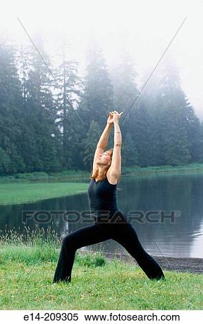 Woman performing yoga along Wark Lake. Ketchikan, Alaska. USA View Large Photo Image Stock Photography - Woman performing yoga along Wark Lake. Ketchikan, Alaska. USA. Fotosearch
