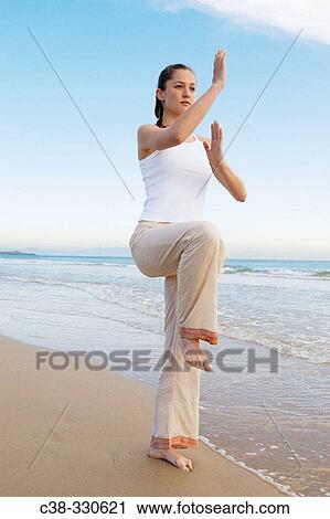 Woman performing yoga View Large Photo Image Stock Image - Woman performing yoga. Fotosearch