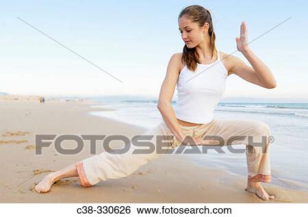 Woman performing yoga View Large Photo Image Stock Photograph - Woman performing yoga. Fotosearch