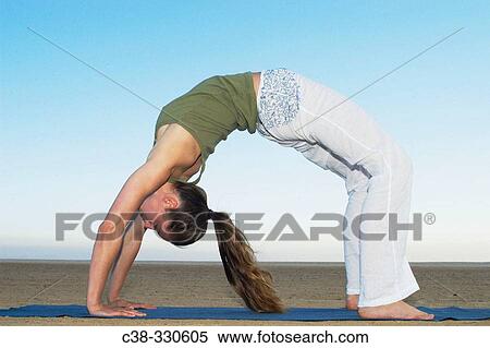 Stock Photography - Woman performing yoga. Fotosearch