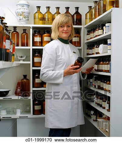 Woman pharmacist preparing a prescription. View Large Photo Image Stock Image - Woman pharmacist preparing a prescription.. Fotosearch