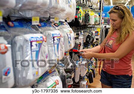 Woman picking clothes from a socks shelf at a store aisle View Large Photo Image Stock Photography - Woman picking clothes from a socks shelf at a store aisle. Fotosearch