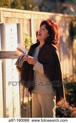 Woman picking up the mail View Large Photo Image Stock Photo - Woman picking up the mail. Fotosearch