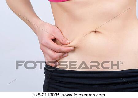 Woman pinching skin to measure fat around waist. View Large Photo Image Stock Photography - Woman pinching skin to measure fat around waist.. Fotosearch