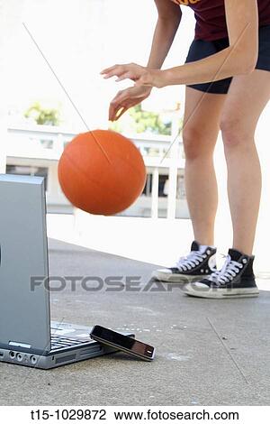woman playing basketball with laptop and iphone in the foreground View Large Photo Image Stock Image - woman playing basketball with laptop and iphone in the foreground. Fotosearch