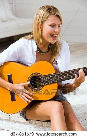Woman playing guitar outdoors View Large Photo Image Stock Photo - Woman playing guitar outdoors. Fotosearch