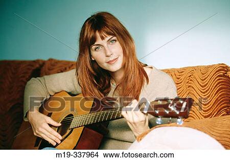 Picture - Woman playing guitar. Fotosearch