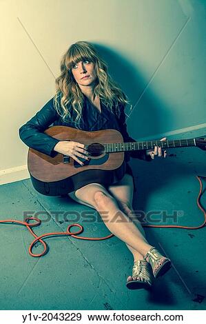 Stock Photo - Woman playing guitar.. Fotosearch