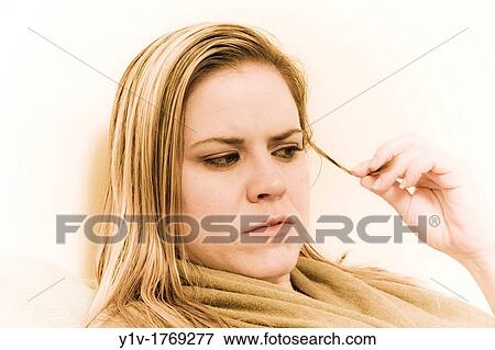 Stock Photo - Woman playing with her hair. Fotosearch