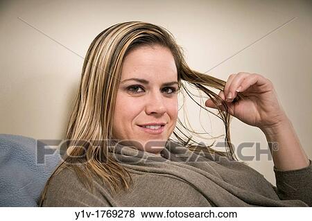Stock Photo - Woman playing with her hair. Fotosearch