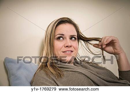 Stock Photo - Woman playing with her hair. Fotosearch