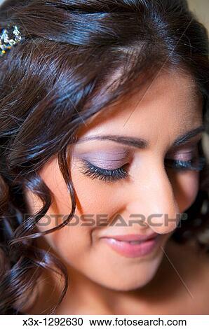 Stock Image - Woman portrait looking down. Fotosearch