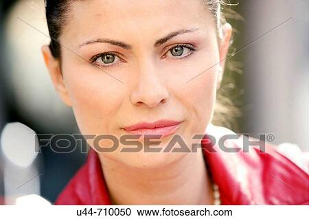 Stock Image - Woman portrait with red leather jacket. Fotosearch