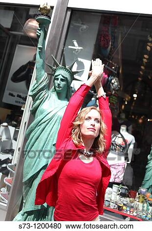 Woman poses front an Liberty Statue copy in Manhattan, New York City, USA View Large Photo Image Stock Image - Woman poses front an Liberty Statue copy in Manhattan, New York City, USA. Fotosearch