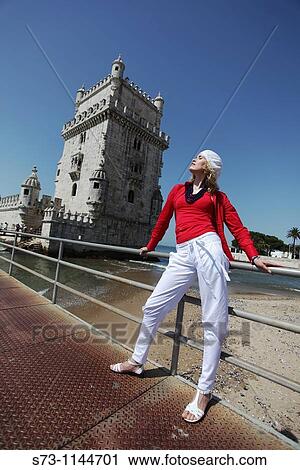 Stock Image - Woman poses front Belem Tower, Lisbon, Portugal. Fotosearch