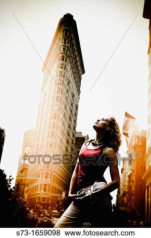 Woman poses front the Flatiron building, Manhattan, New York City, USA View Large Photo Image Stock Photo - Woman poses front the Flatiron building, Manhattan, New York City, USA. Fotosearch
