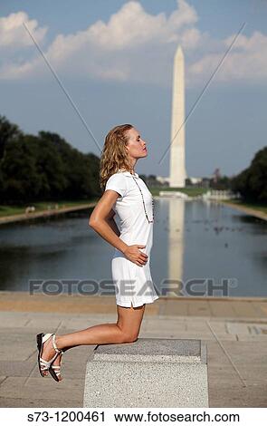 Stock Image - Woman poses front Washington Monument. Fotosearch
