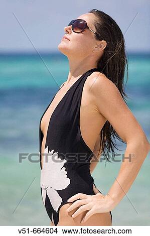 Woman posing and sunbathing on the beach. View Large Photo Image Picture - Woman posing and sunbathing on the beach.. Fotosearch