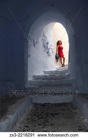 Woman posing at a passageway in Pyrgos town, Santorini, Cyclades Islands, Greek Islands, Greece, Europe. View Large Photo Image Stock Image - Woman posing at a passageway in Pyrgos town, Santorini, Cyclades Islands, Greek Islands, Greece, Europe.. Fotosearch