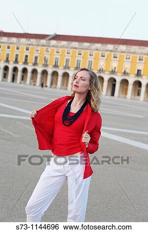 Stock Photograph - Woman posing at Pra? a Do Comercio in Lisbon, Portugal, Europe. Fotosearch