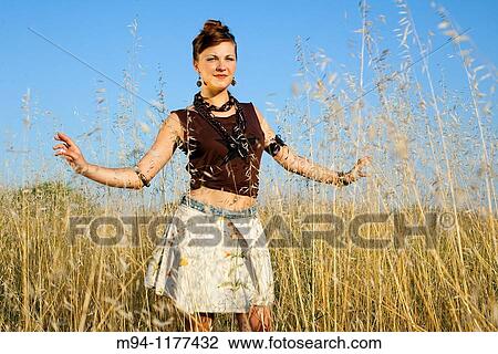 Stock Image - Woman posing, facing camera. Fotosearch