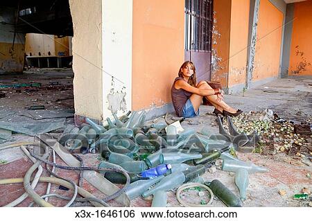 Stock Photograph - Woman posing in an abandoned wine factory. Fotosearch