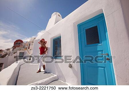 Woman posing in front of a Cyclades house in Oia town, Santorini, Cyclades Islands, Greek Islands, Greece, Europe. View Large Photo Image Stock Image - Woman posing in front of a Cyclades house in Oia town, Santorini, Cyclades Islands, Greek Islands, Greece, Europe.. Fotosearch