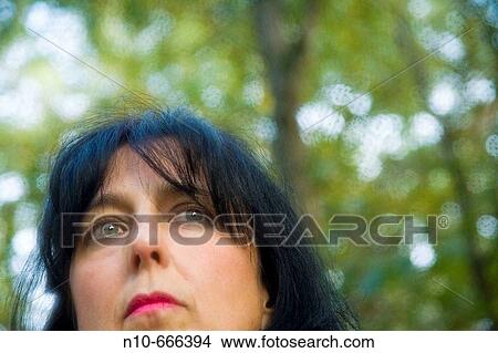 Woman posing in her backyard. View Large Photo Image Picture - Woman posing in her backyard.. Fotosearch