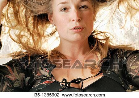 Woman posing in the studio with strong light behind View Large Photo Image Stock Image - Woman posing in the studio with strong light behind. Fotosearch