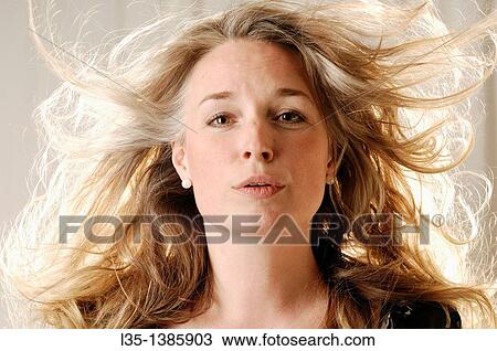 Woman posing in the studio with strong light behind View Large Photo Image Stock Image - Woman posing in the studio with strong light behind. Fotosearch