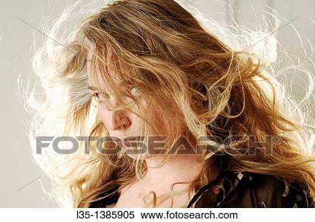 Woman posing in the studio with strong light behind View Large Photo Image Stock Photography - Woman posing in the studio with strong light behind. Fotosearch