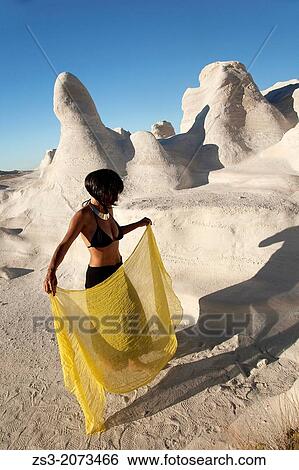 Woman posing near the white rock forms in Sarakiniko beach, Milos, Cyclades Islands, Greek Islands, Greece, Europe. View Large Photo Image Stock Photograph - Woman posing near the white rock forms in Sarakiniko beach, Milos, Cyclades Islands, Greek Islands, Greece, Europe.. Fotosearch