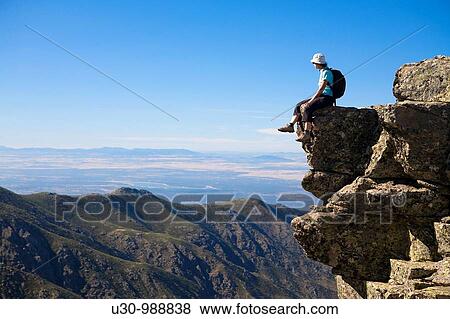 Stock Photo - Woman practice mountaineering in the mountains of the Sierra de Gredos National Park Valley of the Garganta L? brega Navacepeda de Tormes? vila Castilla y Le? n Spain. Fotosearch