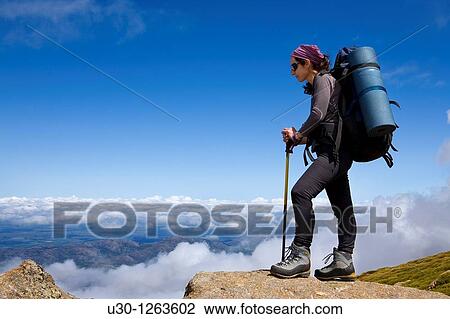 Stock Image - Woman practicing mountaineering in the Sierra de B? jar Natural Park, in Salamanca province, Biosphere Reserve of Sierra de B? jar and Francia. Fotosearch