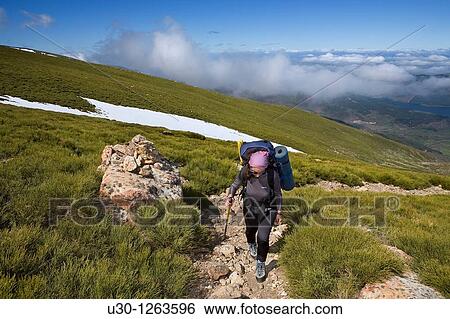 Stock Photograph - Woman practicing mountaineering in the Sierra de B? jar Natural Park, in Salamanca province, Biosphere Reserve of Sierra de B? jar and Francia. Fotosearch
