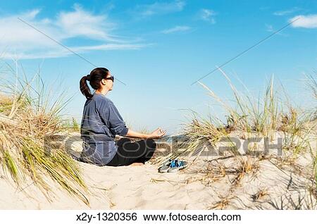 Woman practicing yoga at the beach, Cape Cod View Large Photo Image Stock Photograph - Woman practicing yoga at the beach, Cape Cod. Fotosearch